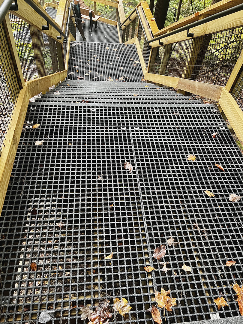 Fiberglass floor grating steps with wire mesh handrail inserts at a national park, similar to products from Direct Metals®.
